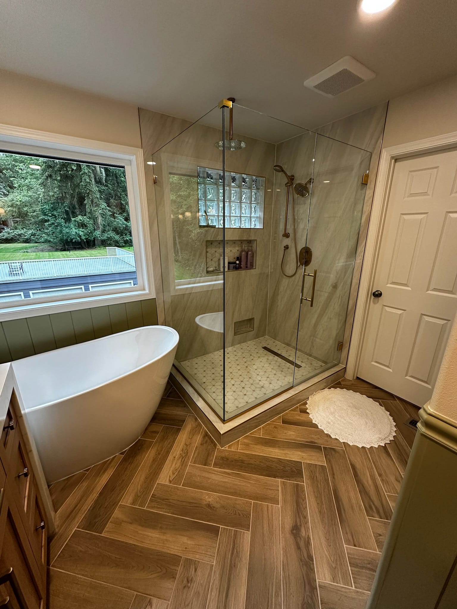 MVS bathroom remodel with a freestanding bathtub, glass shower and brass fixtures